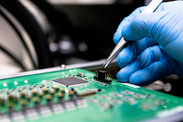 close up of a pcb being assembled