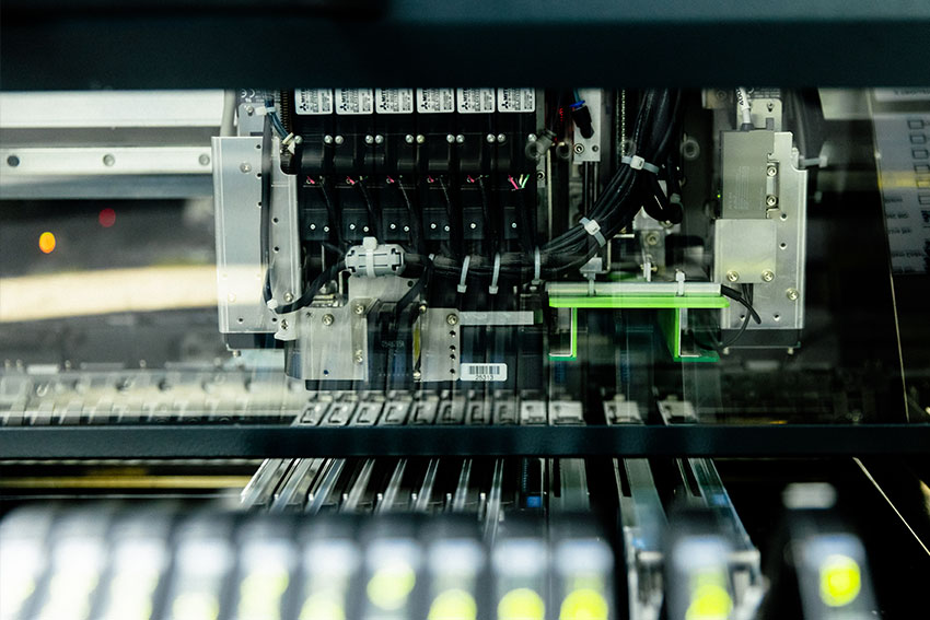 close up of a juki machine assembling components