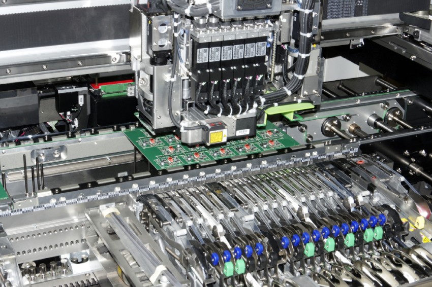 blue circuit board inside a juki machine