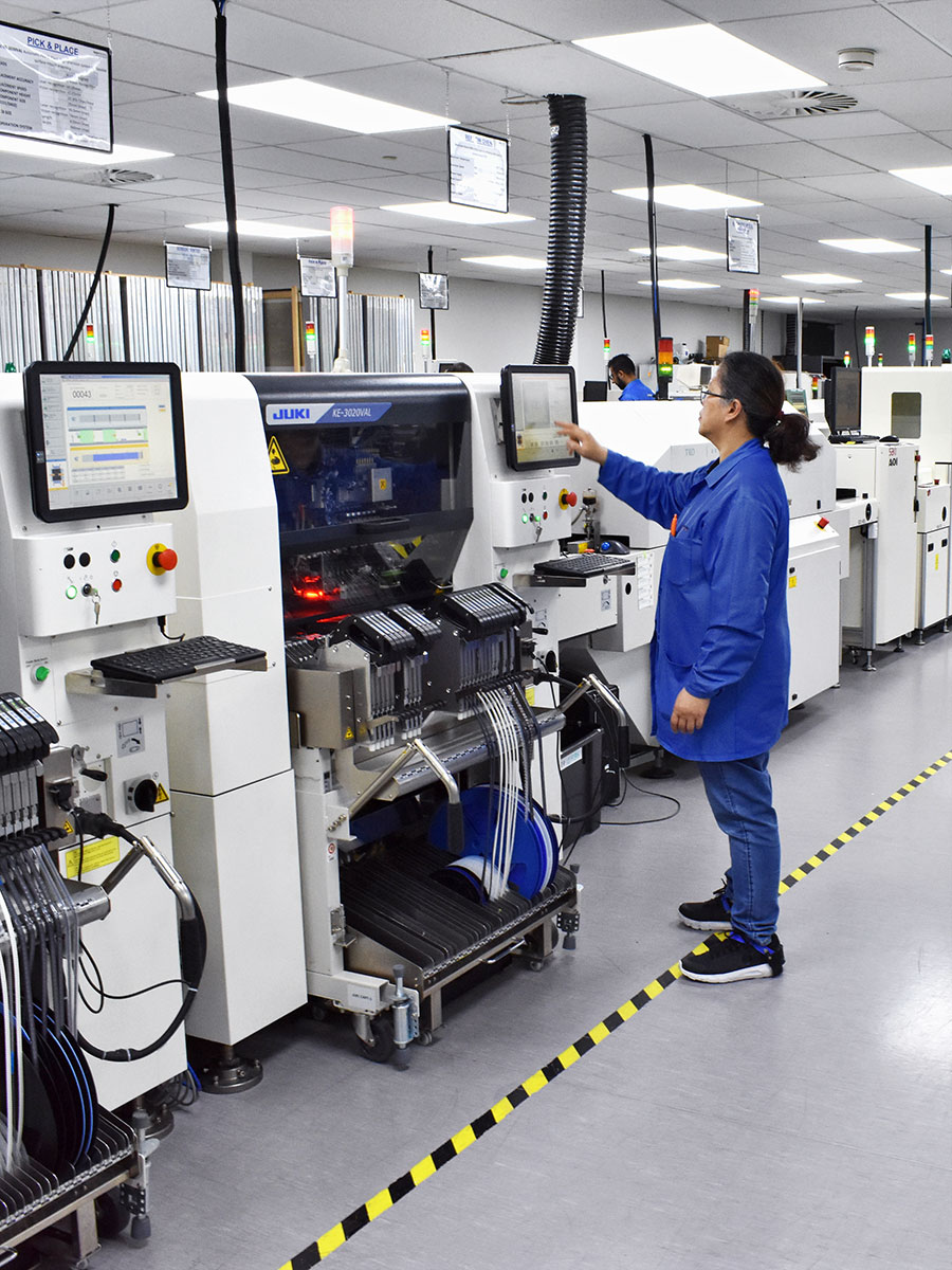 woman electrical engineer operating a juki machine